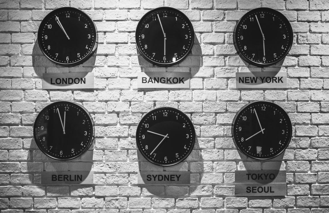 Alt text: Clocks showing different time zones.